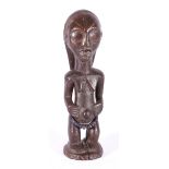 DRC standing carving of a female fertility figure, scarified face and bead decoration to the waist,