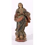 Antique painted pine figure of a saint, above angel masks, on an octagonal base, some losses, 30cm.