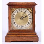 Hamilton & Inches oak mantel timepiece, the brass dial with silvered Roman chapter, 21cm.