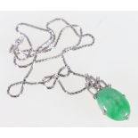 Chinese jade and diamond pendant with oval cabochon jade and six small diamond brilliants on 585