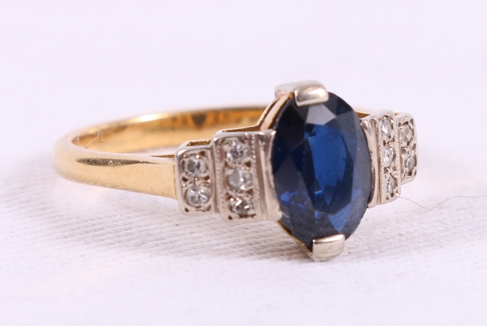 Ring with oval sapphire flanked by ten eight cut diamonds in 18ct gold.