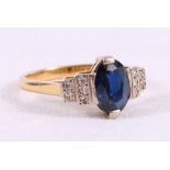 Ring with oval sapphire flanked by ten eight cut diamonds in 18ct gold.