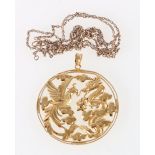 Chinese yellow metal openwork pendant depicting a Kylin and bird of paradise fighting over a