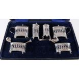 Victorian six piece silver cruet set with blue glass liners in fitted case, Birmingham 1893,