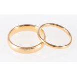 18ct yellow gold wedding band, 4.14g, size K and another thinner, 1.40g, size I/J.