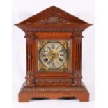 Oak cased mantle clock of architectural form with brass dial, Roman numeral chapter ring,