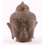 South East Asian bronze Buddhas head, possibly 18th century, with stylized curly hair and usnisa,