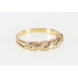 Gold ring with twisted bands of mixed cut diamonds in 18ct gold.