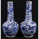 Pair of 19th century Chinese bottle vases depicting confronting dragons, Kang Xi mark to base, 25cm.