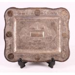 Indian silver card tray with relief and punched decoration depicting village scenes,