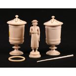 A pair of carved ivory containers in the form of urns with pierced carved lids,