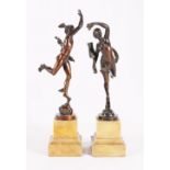Pair of bronze figures, the female holding cornucopia and banner upon wheel,