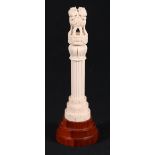 Early 20th century carved ivory column on tiered base with four lions and animal frieze above a