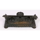 19th century bronze ink stand with urn finial, two inkwell division and pen well, acanthus handles,