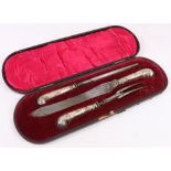 Silver handled three piece carving set with pistol handles in fitted case.