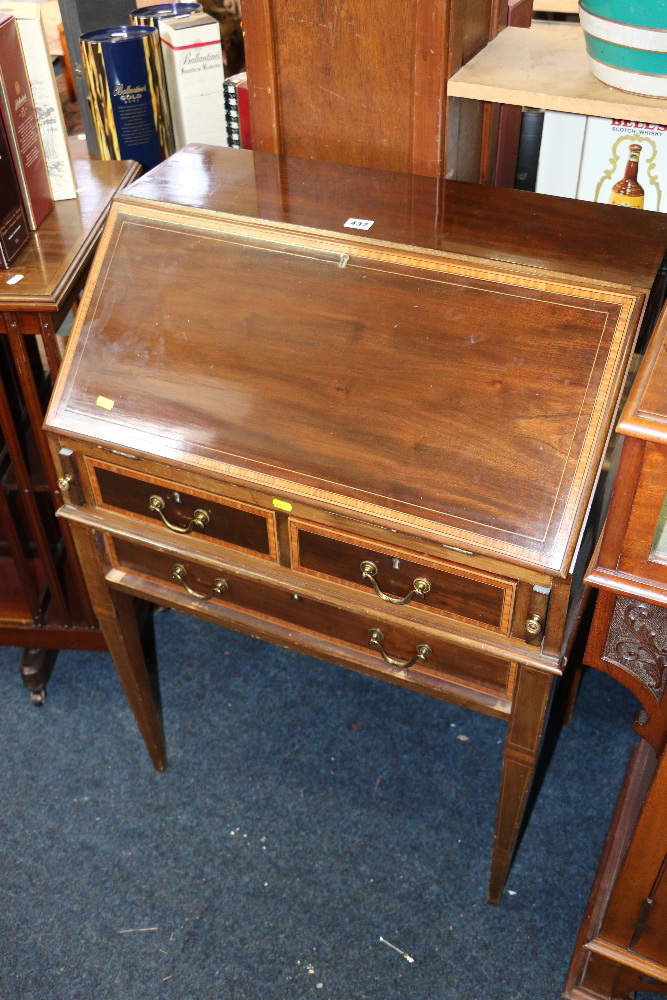 Mahogany and inlaid bureau raised on tapering supports, 68cm wide.