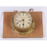 Whyte and Thomson & Co brass bulkhead clock on mahogany plinth,