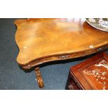 Victorian rosewood library or centre table with shaped edge above two drawers raised on trestle