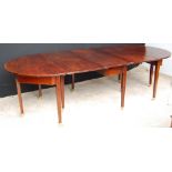 Victorian extending D-end mahogany dining table with square tapered legs and brass castors,