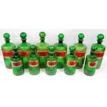 Set of eleven green ribbed pharmacy jars and stoppers,