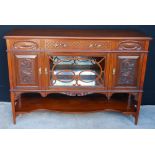 Edwardian carved mahogany sideboard with mirrored glazed centre compartment and undertier,