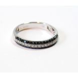 Half eternity style ring with a band of tiny diamond brilliants flanked by black diamonds,