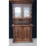 Profusely carved Breton style bookcase, 228cm high, 118cm wide and 49cm deep.