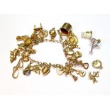 9ct gold charm bracelet with eighteen charms and four others, loose, some 9ct.