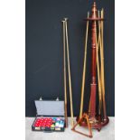 Modern mahogany circular cue stand, 164cm, six cues, two rests,