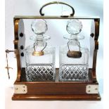 Edwardian mounted oak tantalus with diamond and hobnail cut square decanters,