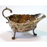 Irish silver sauce boat, typically embossed with animals and other designs,