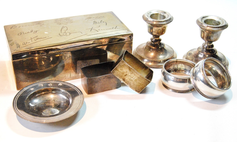 Silver cigarette box, two pairs of napkin rings,