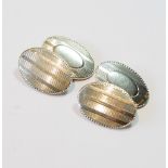 Pair of white gold oval cufflinks with engine-turned border, '14k'.