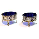 Pair of silver pierced oval salts of Georgian style on claw and ball feet, Birmingham 1904,