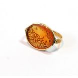 Antique ring with carnelian intaglio head of Medusa in oval bezel swivelling upon slender gold band,