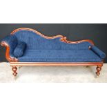 Victorian mahogany chaise longue with blue buttoned upholstery on baluster legs and brass castors,