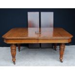 Victorian oak wind-out extending dining table with two extra leaves, on fluted tapered legs,