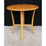 Ercol circular oak table on four splayed legs, 63cm high and 61cm diameter.