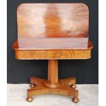 Victorian mahogany fold-over tea table on an octagonal support, plinth base and bun feet,