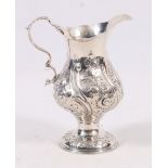 George III silver cream jug, of baluster form, with embossed scrolls and foliage, hallmarks unclear,