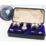 Cased silver three piece cruet set, maker GU,