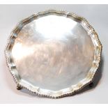 Silver circular tray with shaped, moulded and gadrooned edge, on pad feet, by Lowe, Chester 1938,