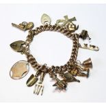 Gold curb bracelet with various charms, mostly 9ct. Condition Report 26.