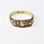 Edwardian gold half hoop ring with three pearls and two pairs of tiny diamond brilliants, '18'.