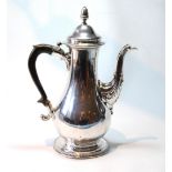 Silver coffee pot of baluster shape with scrolling spout and beaded edges, crested,