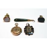 19th century garnet pendant, a swivel seal, two others, part gold, and a nephrite pendant.