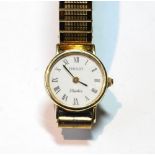 Lady's 9ct gold Tissot Saphir quartz watch on rolled gold bracelet.