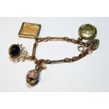 Gold fetter and knot bracelet with four charms dependant.