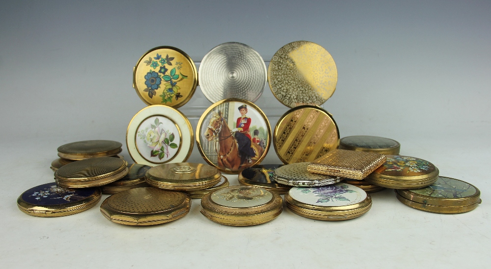 A collection of twenty four brass powder compacts,