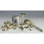 A collection of silver, to include; a cigarette case, a posy vase, three napkin rings,